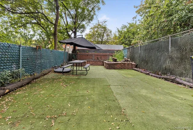 a view of a house with plants and a yard
