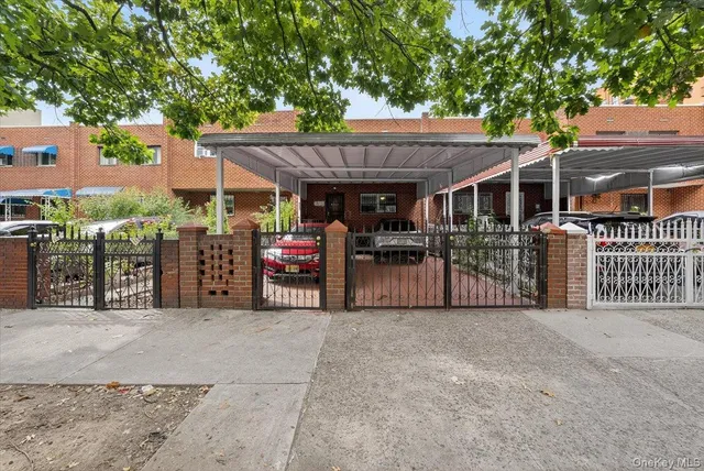 a view of a cars parking space in front of a house