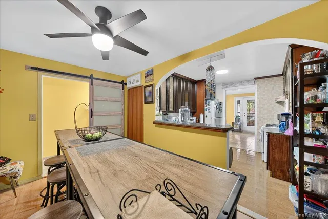 a view of a dining room with furniture and a large window