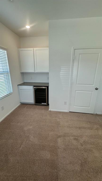 192 Rodney Boat Road Kyle, TX 78640 - Photo 2 of 38 Functional built-in cabinetry and beverage cooler enhance this versatile space.