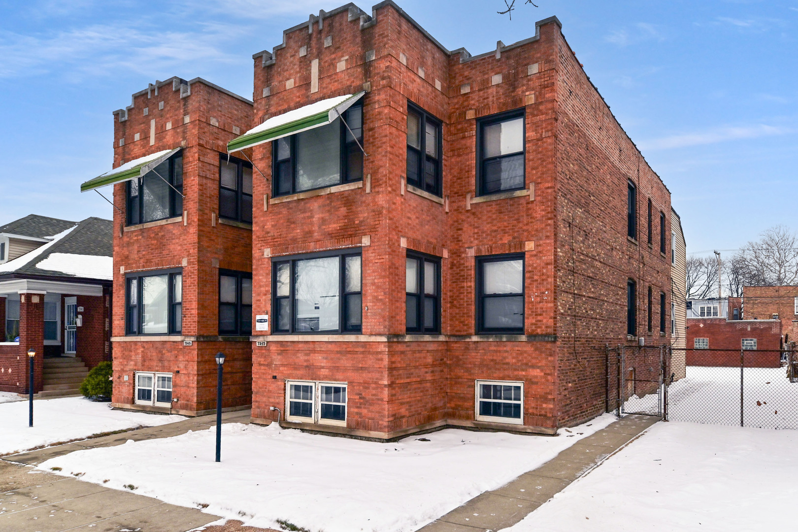 7347 South Calumet Avenue Chicago, IL 60619 - Photo 1 of 27 a view of a brick building next to a road