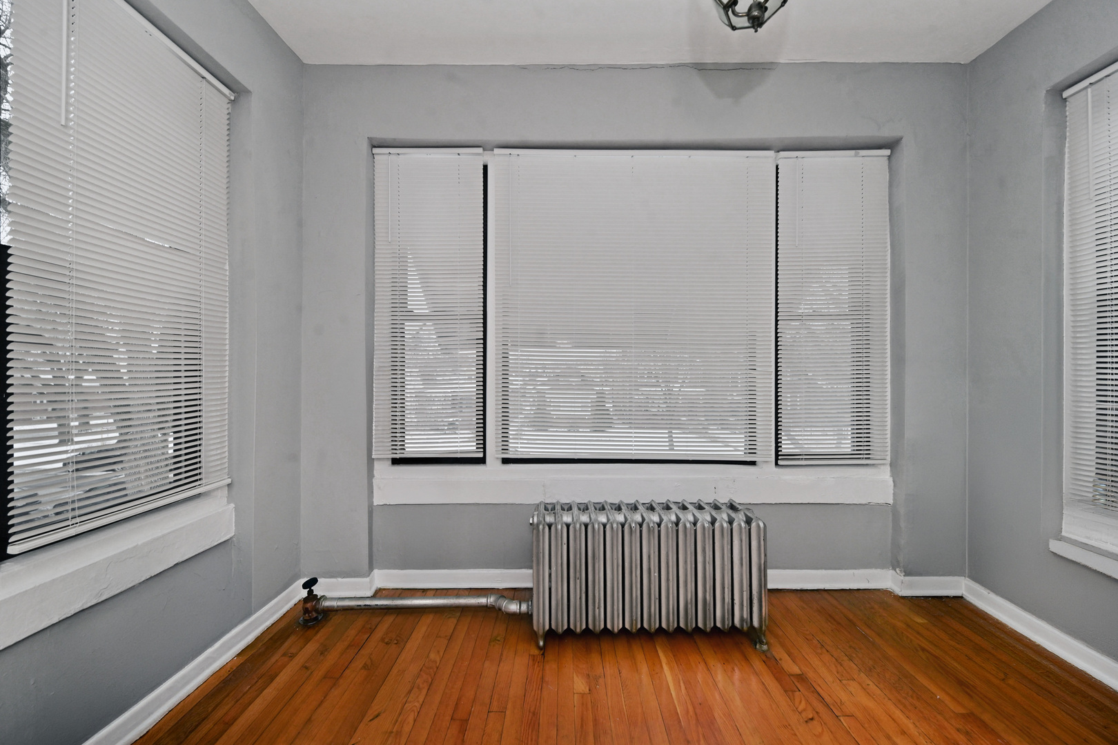 7347 South Calumet Avenue Chicago, IL 60619 - Photo 9 of 27 a room with window and wooden floor