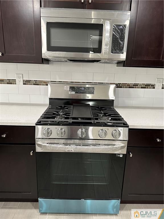 3703 Hana Road Edison, NJ 08817 - Photo 23 of 55 a kitchen with microwave stove and cabinets