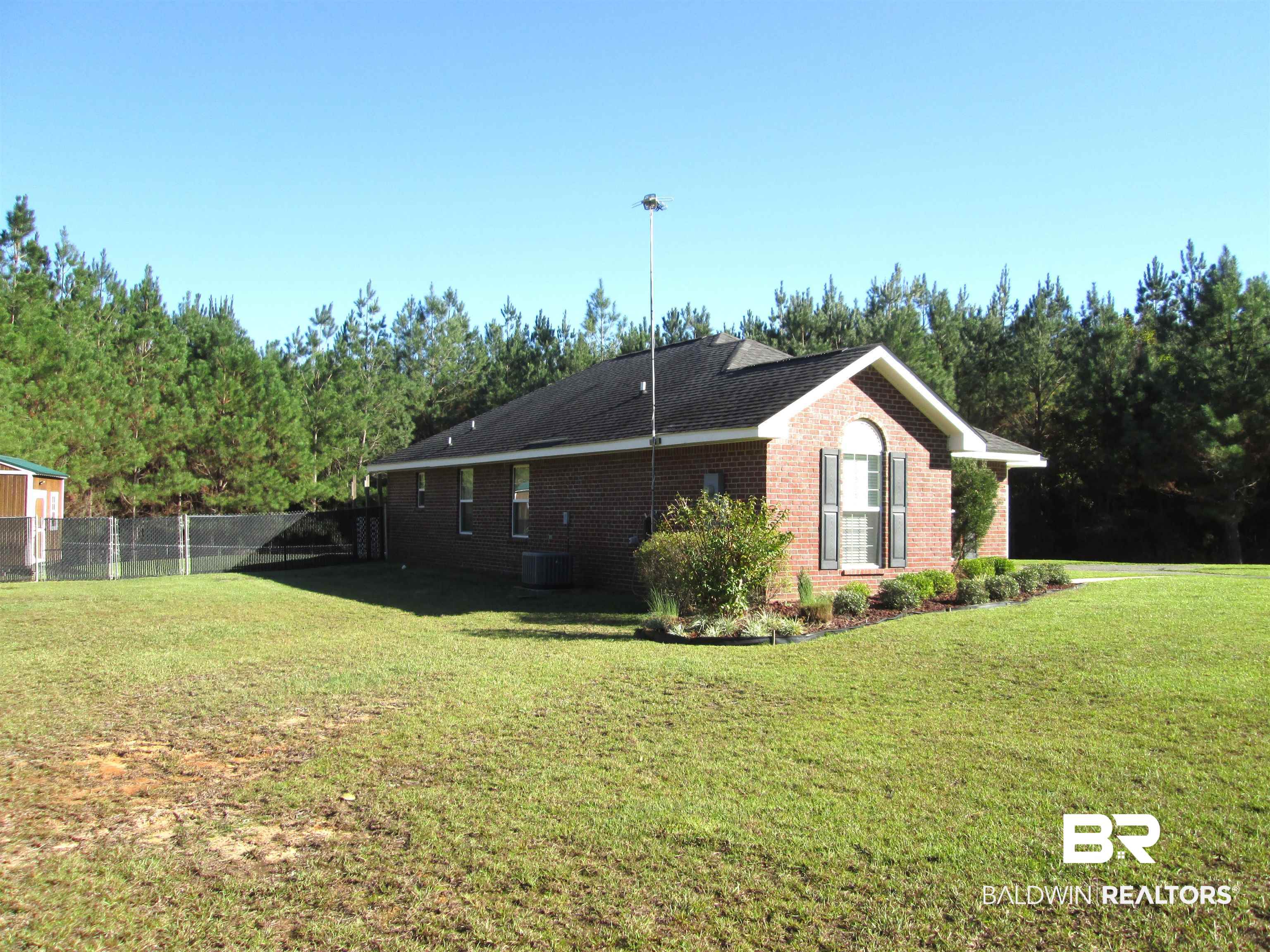 530 Brethren Church Road Fruitdale, AL 36539 - Photo 12 of 24 View of property exterior with central AC and a lawn