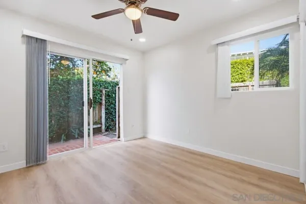 an empty room with closet and windows