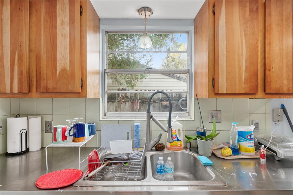 1420 Southwest 42nd Street, Unit B Gainesville, FL 32607 - Photo 18 of 36 a kitchen with a window and cabinets