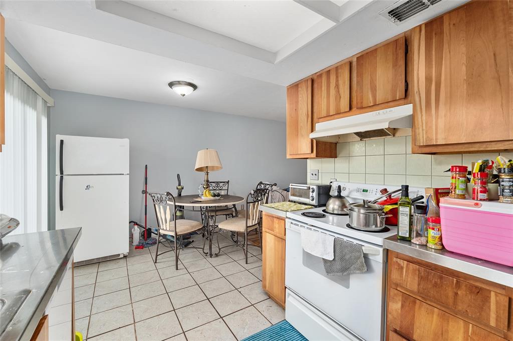 1420 Southwest 42nd Street, Unit B Gainesville, FL 32607 - Photo 19 of 36 a kitchen with a sink a stove and cabinets