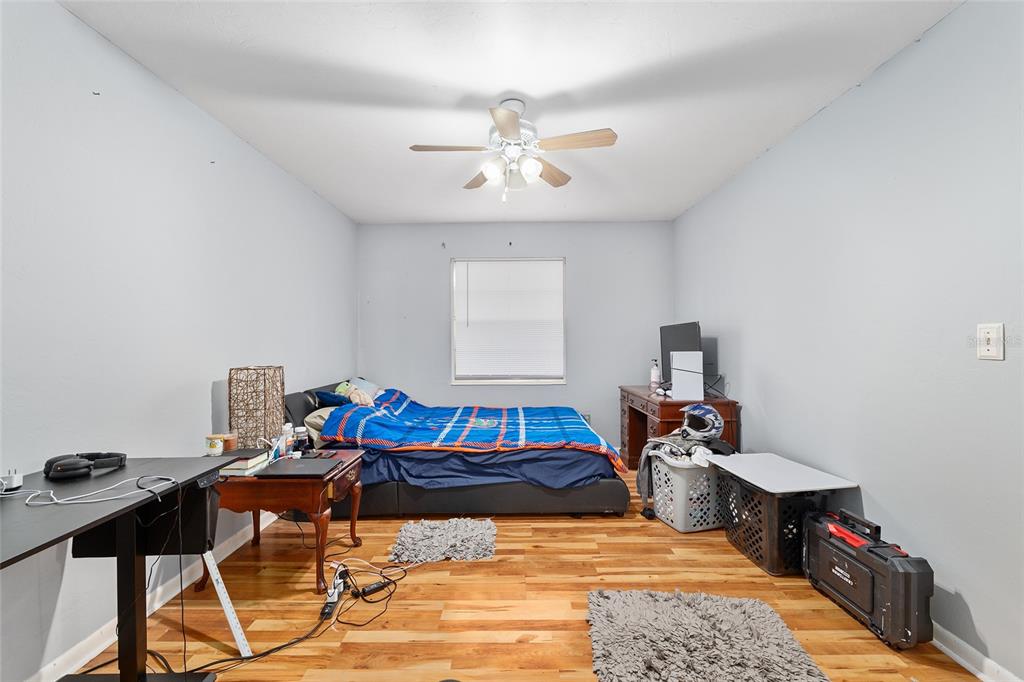 1420 Southwest 42nd Street, Unit B Gainesville, FL 32607 - Photo 22 of 36 a bedroom with a bed and wooden floor