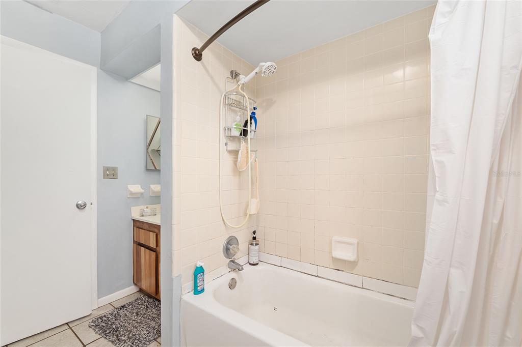 1420 Southwest 42nd Street, Unit B Gainesville, FL 32607 - Photo 28 of 36 a bathroom with a bathtub and a shower