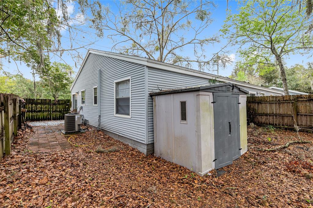 1420 Southwest 42nd Street, Unit B Gainesville, FL 32607 - Photo 32 of 36 a view of a small house with a large tree and wooden fence