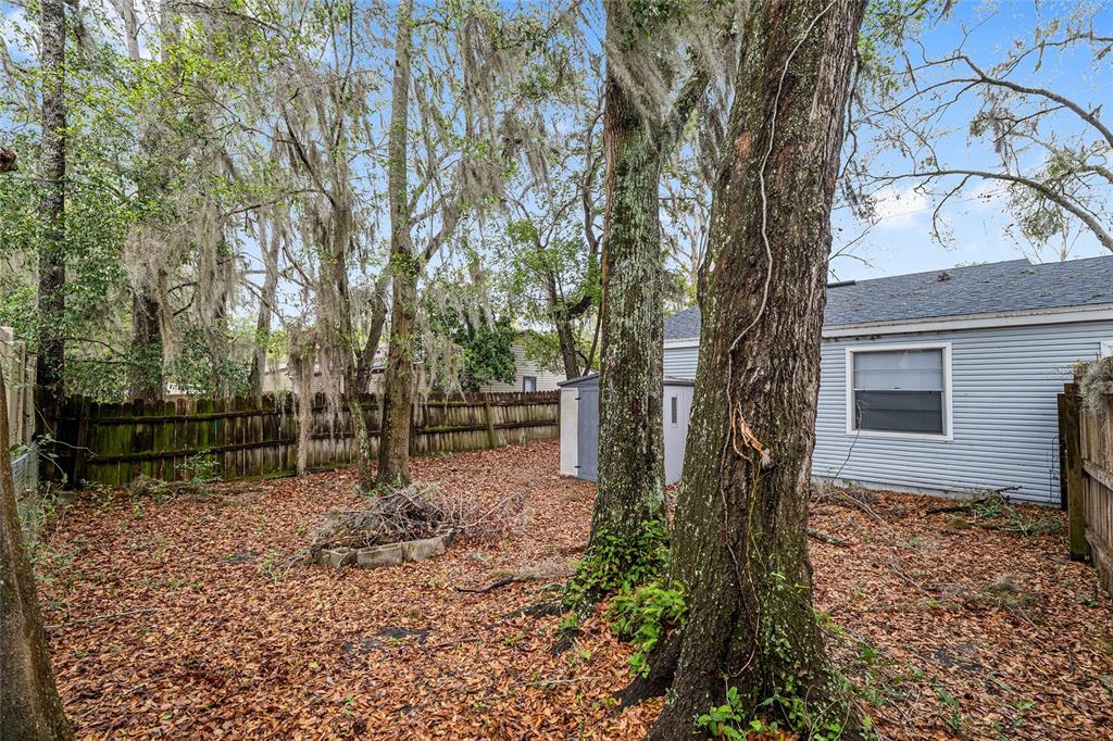 1420 Southwest 42nd Street, Unit B Gainesville, FL 32607 - Photo 35 of 36 a backyard of a house with lots of green space