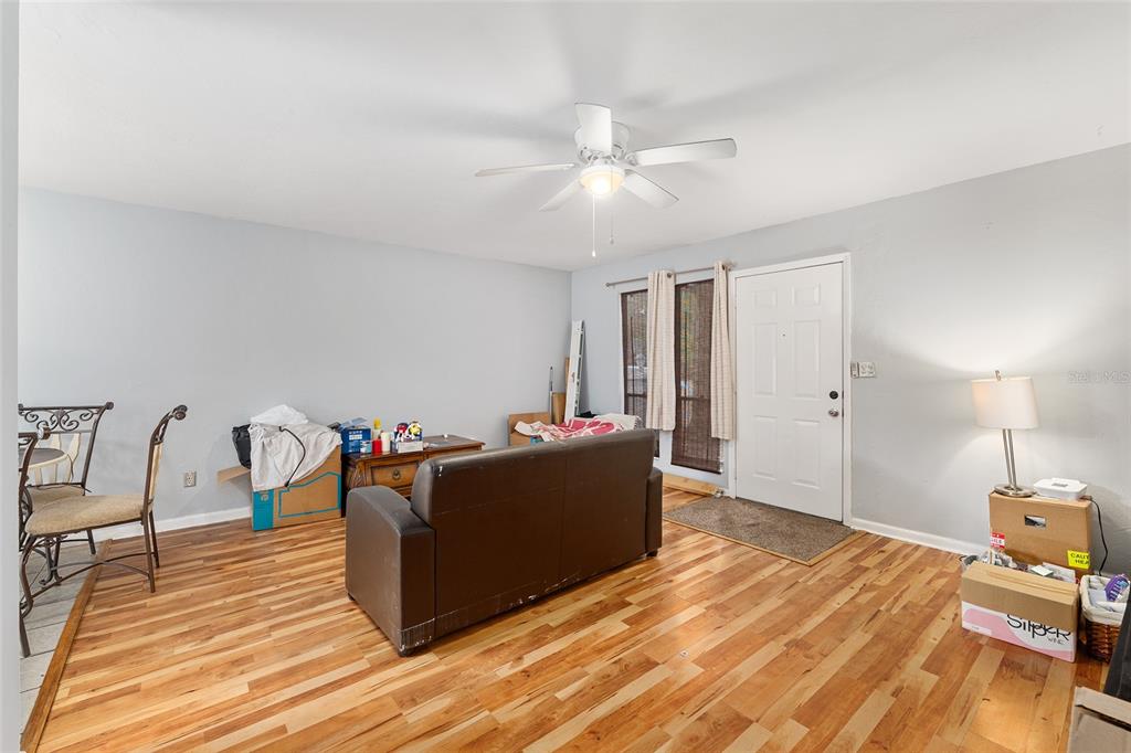 1420 Southwest 42nd Street, Unit B Gainesville, FL 32607 - Photo 8 of 36 a living room with furniture and a wooden floor