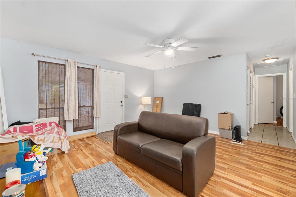 1420 Southwest 42nd Street, Unit B Gainesville, FL 32607 - Photo 10 of 36 a living room with furniture and a wooden floor