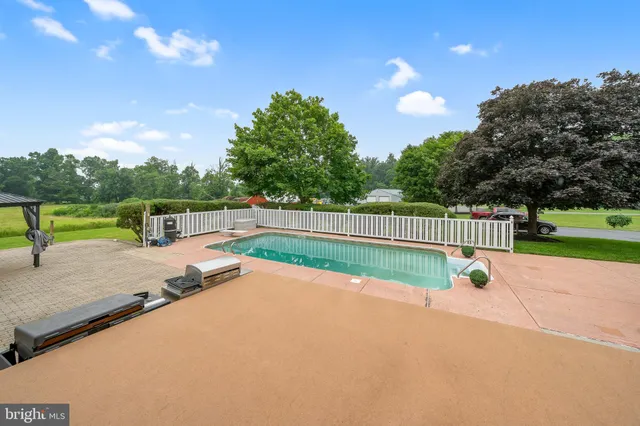 a view of a patio with table and chairs potted plants with wooden fence