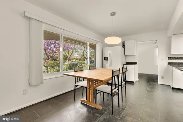 a dining room with furniture and window