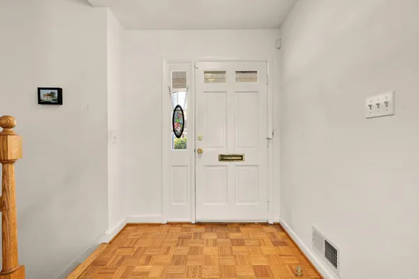 a view of a room with wooden floor