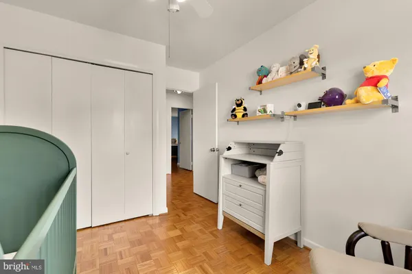 a hallway with cabinets and wooden floor