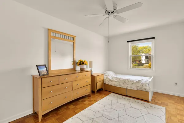 a bedroom with a bed and a dresser