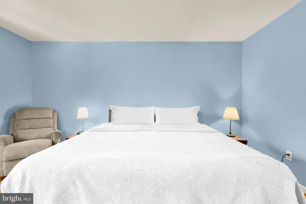 a bedroom with a bed and a lamp