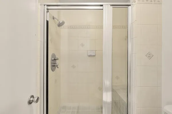 a bathroom with a glass shower door