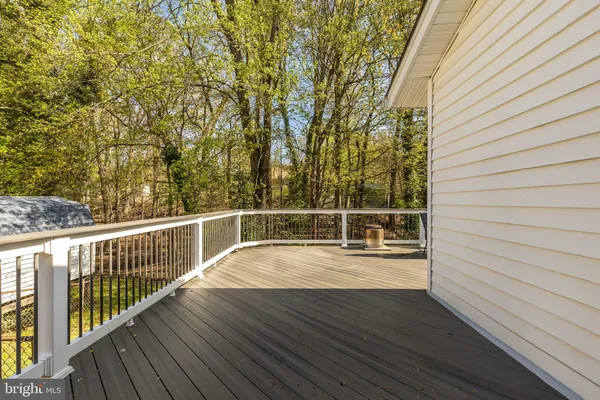 a view of balcony with wooden floor and fence
