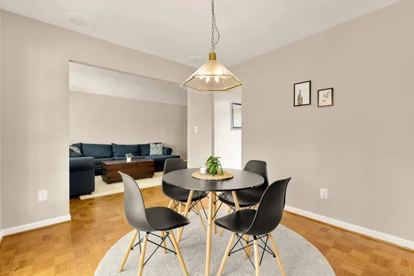a dining room with furniture and wooden floor