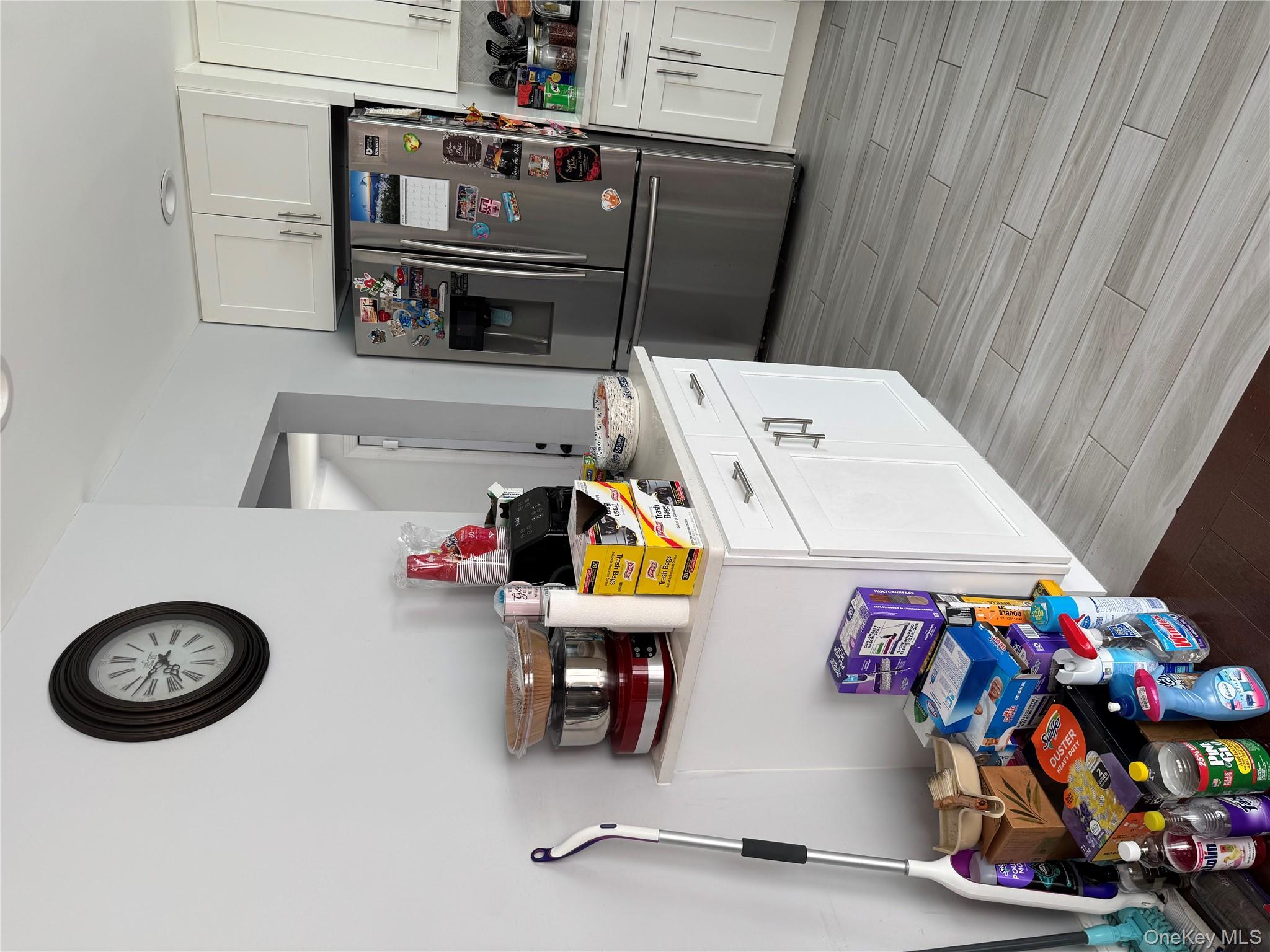 8 Frazier Street Hempstead, NY 11550 - Photo 5 of 7 a kitchen with furniture a clock and wooden floor