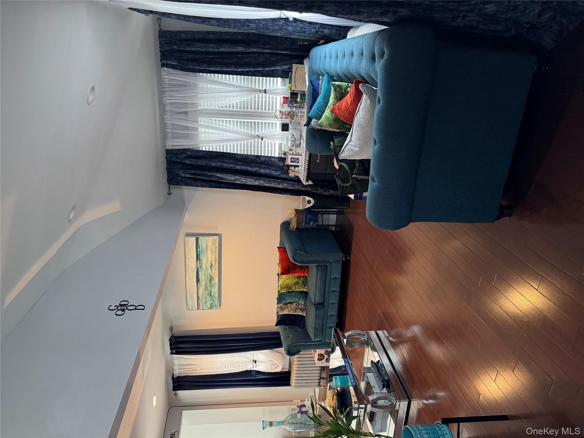 8 Frazier Street Hempstead, NY 11550 - Photo 7 of 7 a living room with furniture and a large window