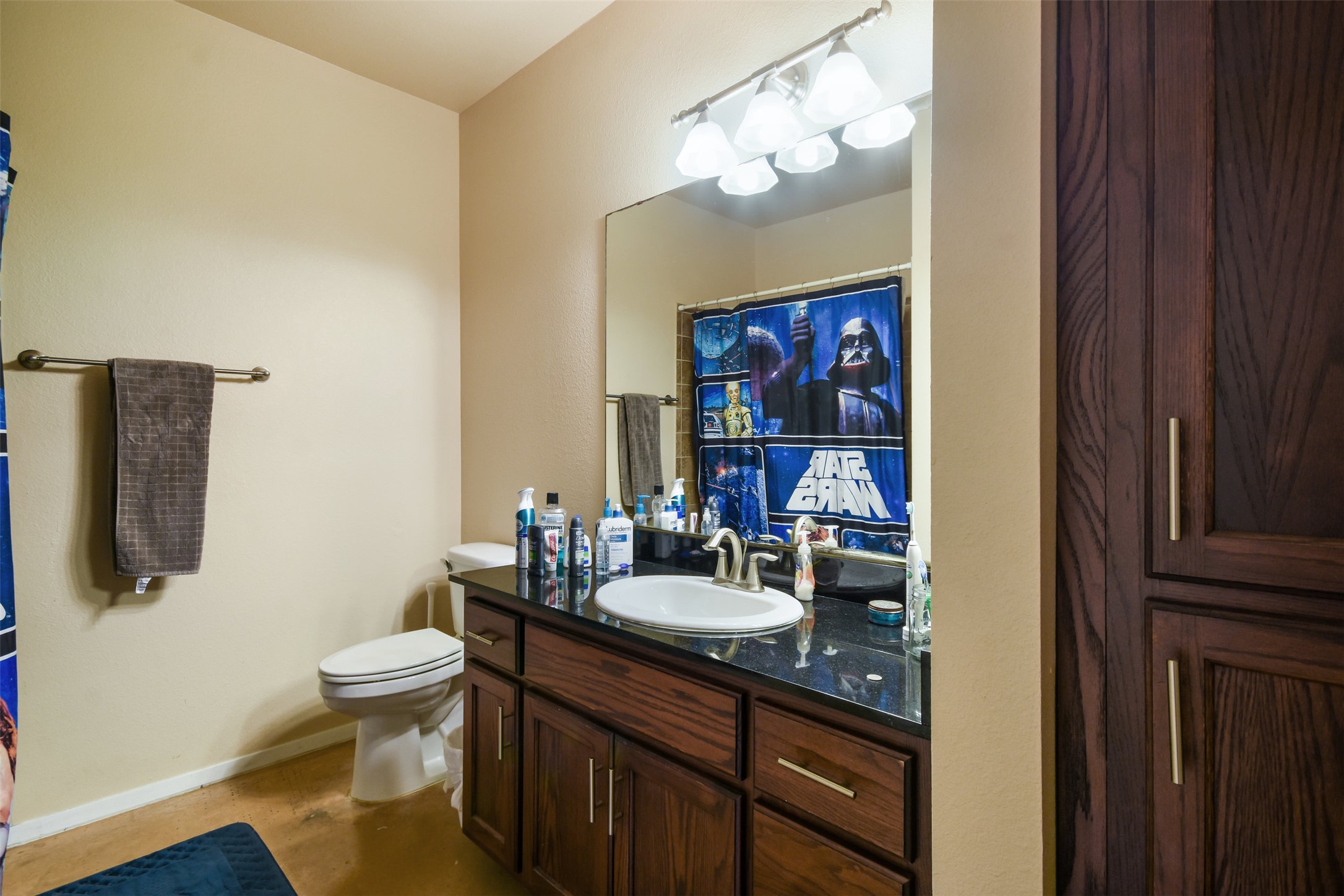 910 West 25th Street, Unit 503 Austin, TX 78705 - Photo 11 of 24 a bathroom with a sink a toilet and a mirror