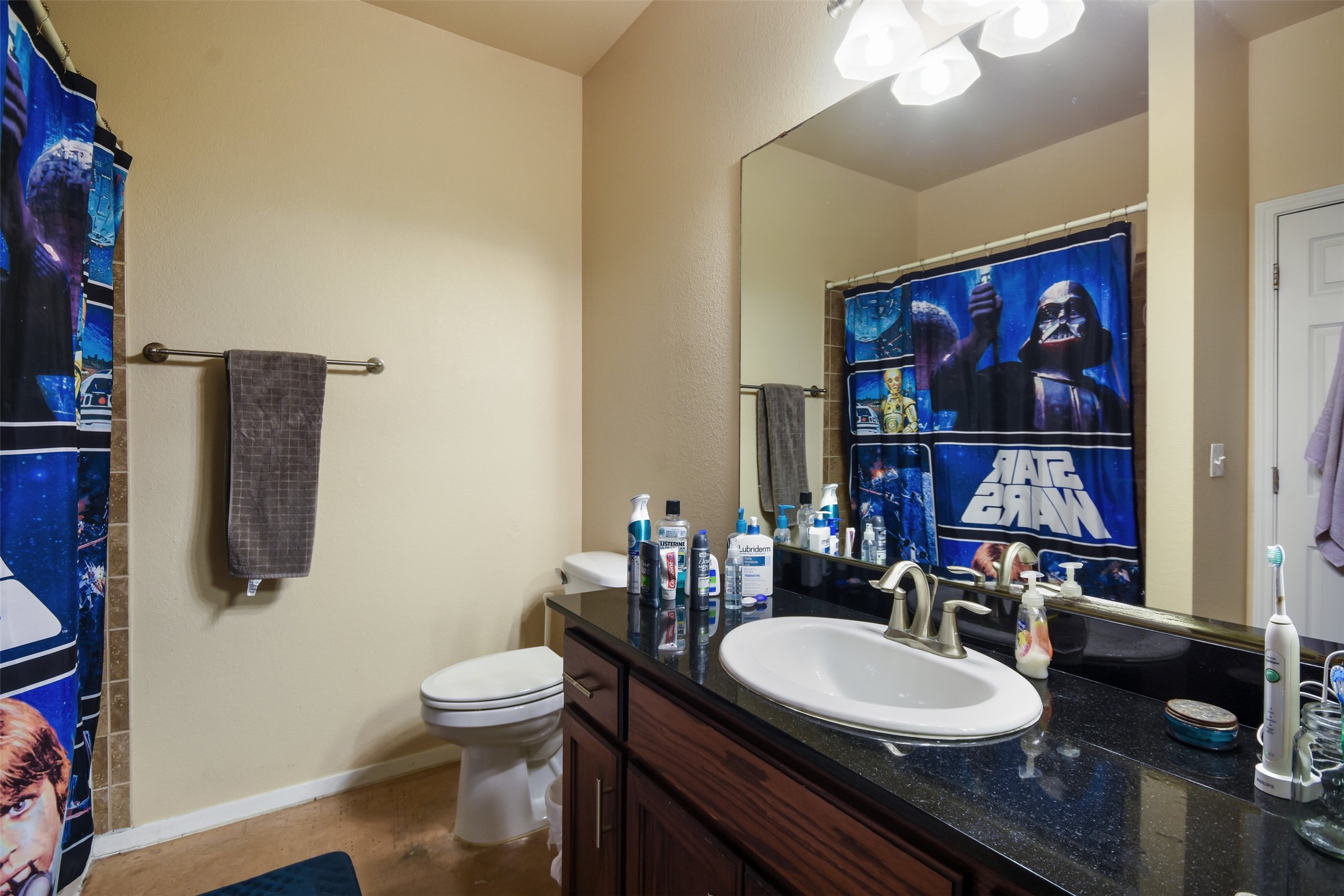 910 West 25th Street, Unit 503 Austin, TX 78705 - Photo 12 of 24 a bathroom with a toilet a sink and a mirror