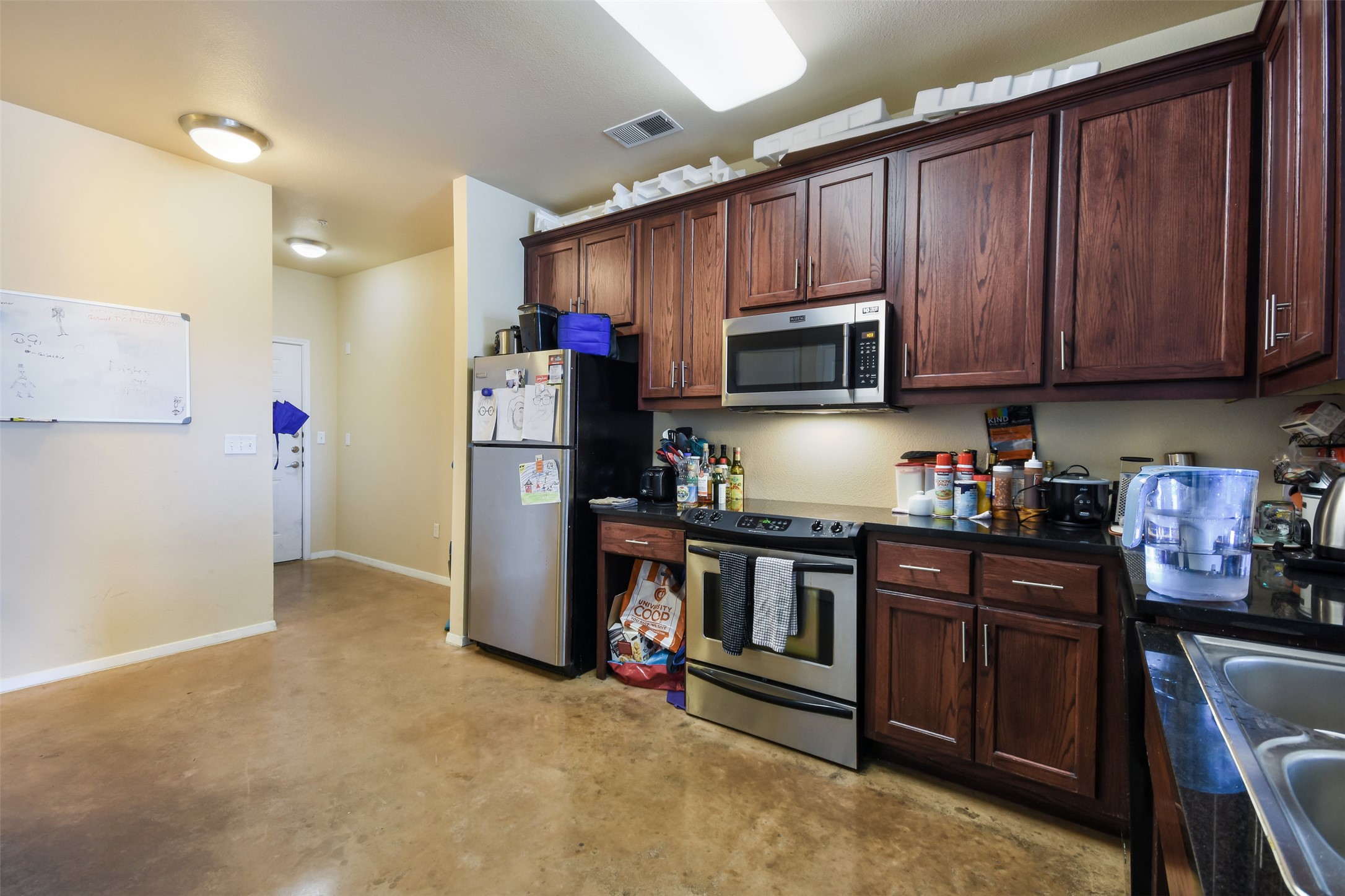 910 West 25th Street, Unit 503 Austin, TX 78705 - Photo 13 of 24 a kitchen with stainless steel appliances granite countertop a refrigerator stove and sink