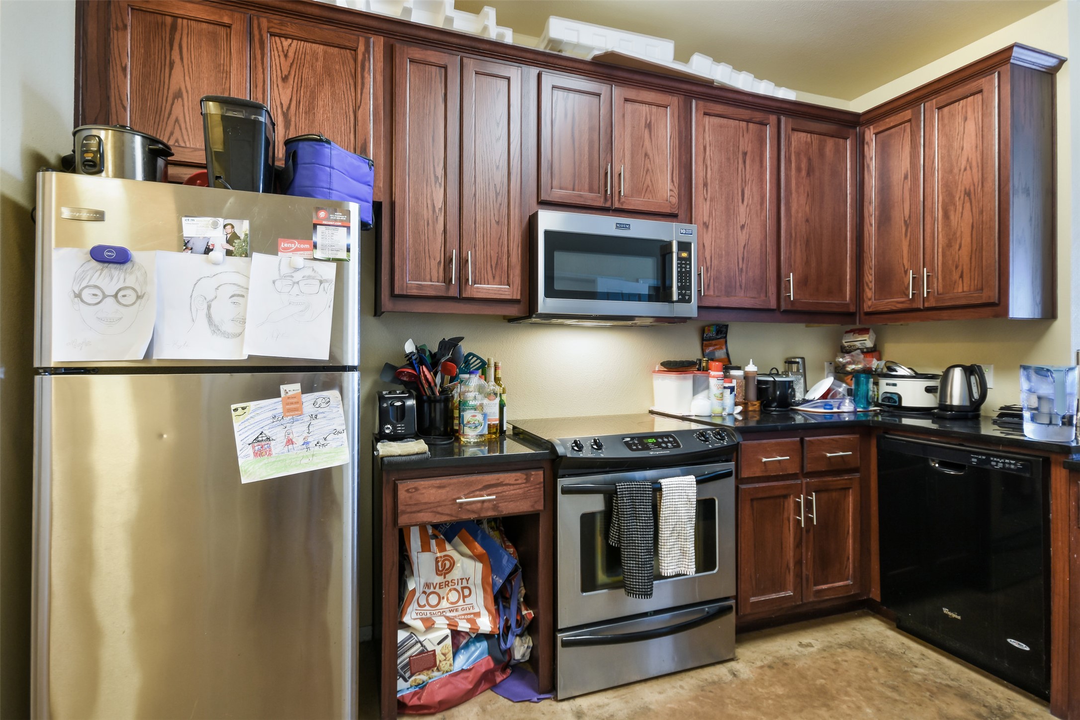 910 West 25th Street, Unit 503 Austin, TX 78705 - Photo 14 of 24 a kitchen with stainless steel appliances granite countertop a refrigerator a stove top oven a sink and dishwasher
