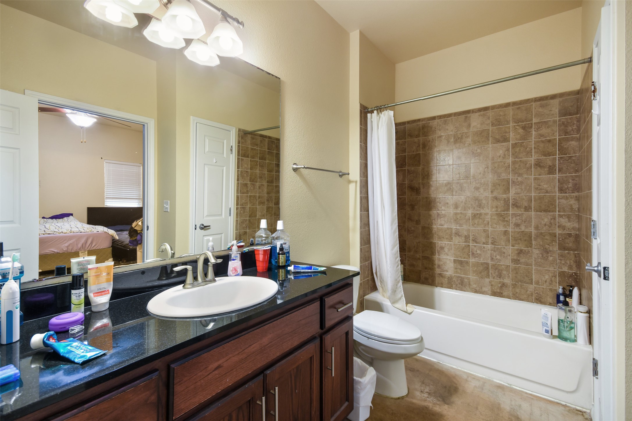 910 West 25th Street, Unit 503 Austin, TX 78705 - Photo 5 of 24 a bathroom with a granite countertop sink toilet mirror and shower
