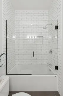 a bathroom with a bathtub and a shower