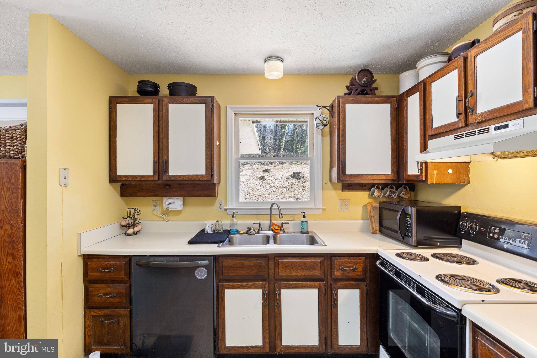 6794 Ottobine Road Dayton, VA 22821 - Photo 11 of 32 a kitchen with a sink stove and microwave