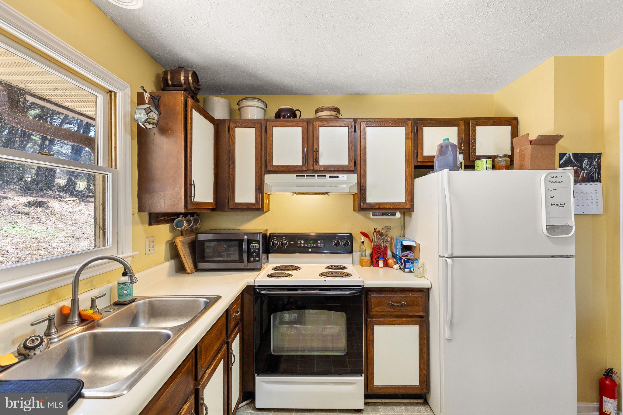 6794 Ottobine Road Dayton, VA 22821 - Photo 12 of 32 a kitchen with stainless steel appliances granite countertop a sink stove and refrigerator