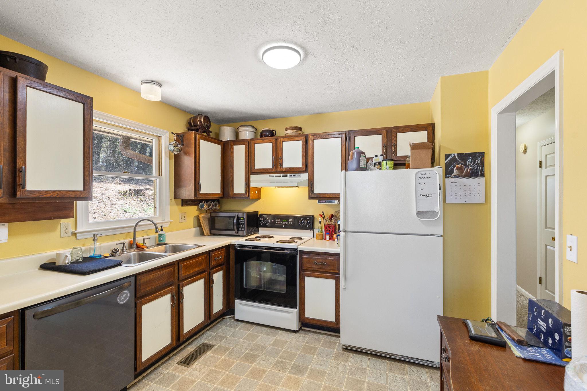 6794 Ottobine Road Dayton, VA 22821 - Photo 10 of 32 a kitchen with a sink a refrigerator and cabinets