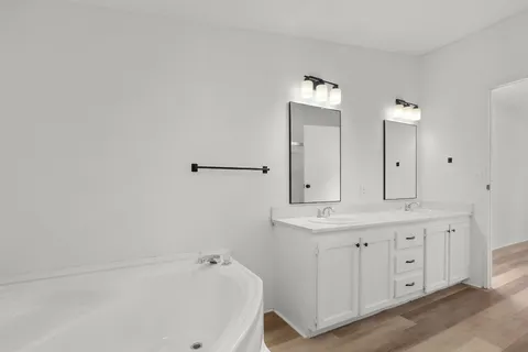 a bathroom with a bathtub and a sink