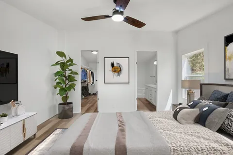 a bedroom with a bed and a flat screen tv