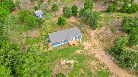 an aerial view of a house with a yard
