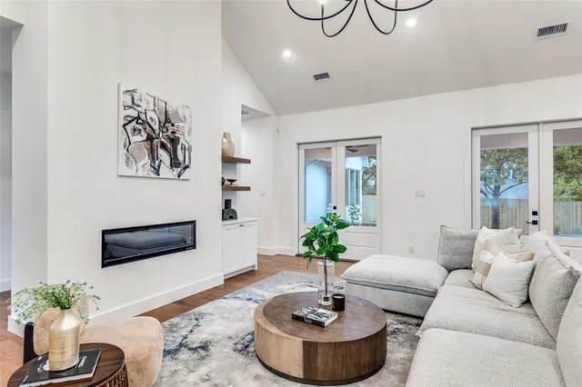 a living room with furniture and a potted plant