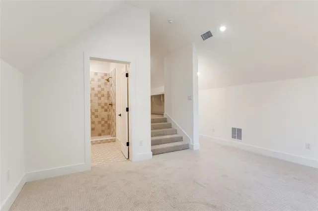 an empty room with a hallway and stairs