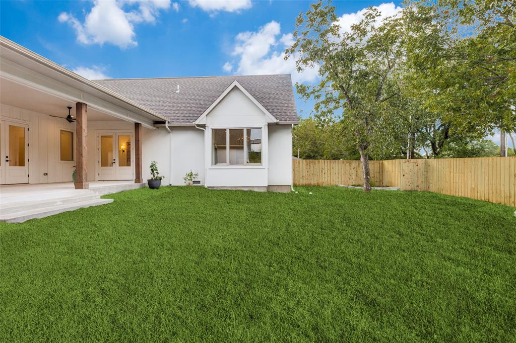 11131 Hillcrest Road Dallas, TX 75230 - Photo 22 of 24 a front view of a house with a yard and trees