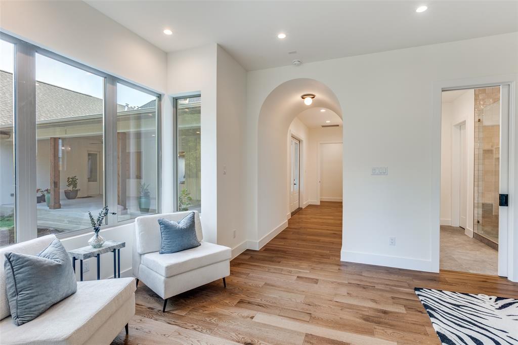 11131 Hillcrest Road Dallas, TX 75230 - Photo 23 of 24 a living room with furniture and a large mirror