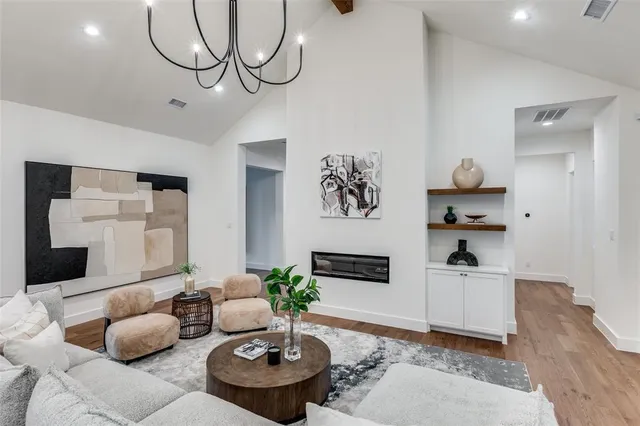 a living room with furniture and a chandelier