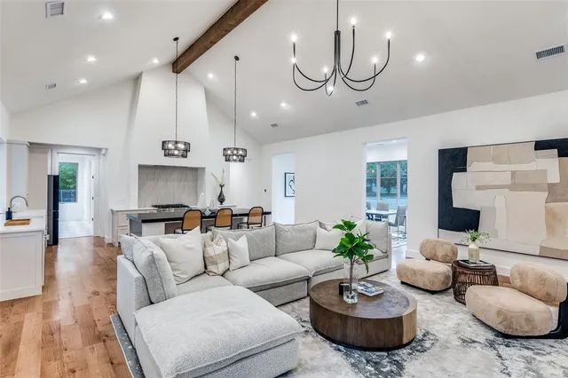 a living room with furniture a rug and a chandelier