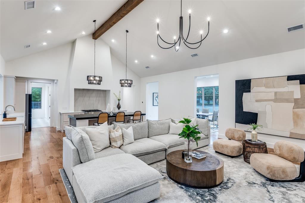 11131 Hillcrest Road Dallas, TX 75230 - Photo 5 of 24 a living room with furniture a rug and a chandelier