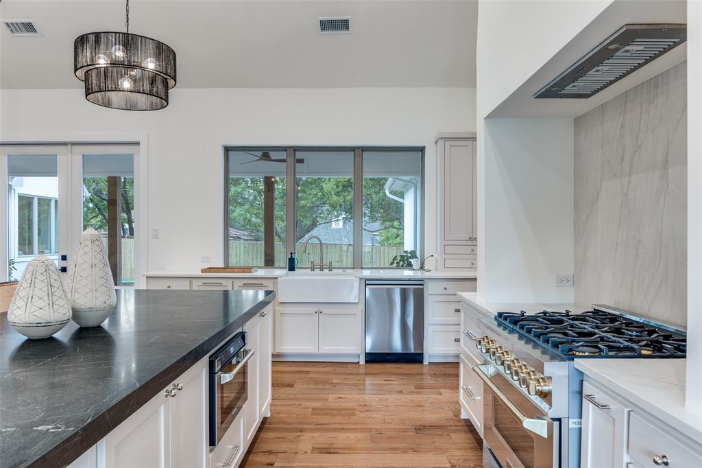 11131 Hillcrest Road Dallas, TX 75230 - Photo 6 of 24 a kitchen with stainless steel appliances a stove a sink a counter space and a window