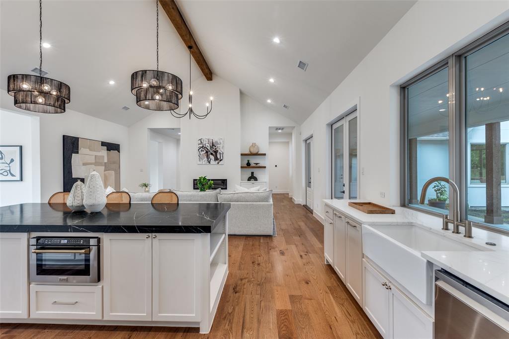 11131 Hillcrest Road Dallas, TX 75230 - Photo 9 of 24 a kitchen with a counter space a sink and stainless steel appliances
