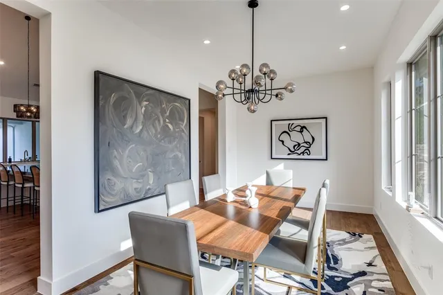 a view of a dining room with furniture wooden floor and a chandelier